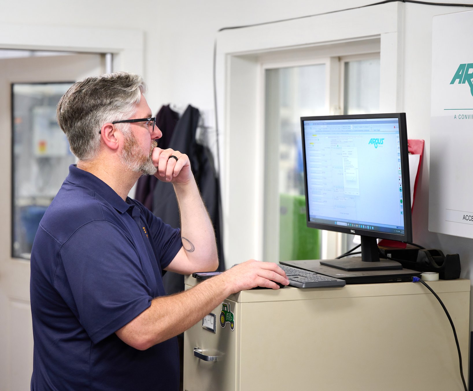 TC Controls programmer reviewing controls logic on the Argus software workstation